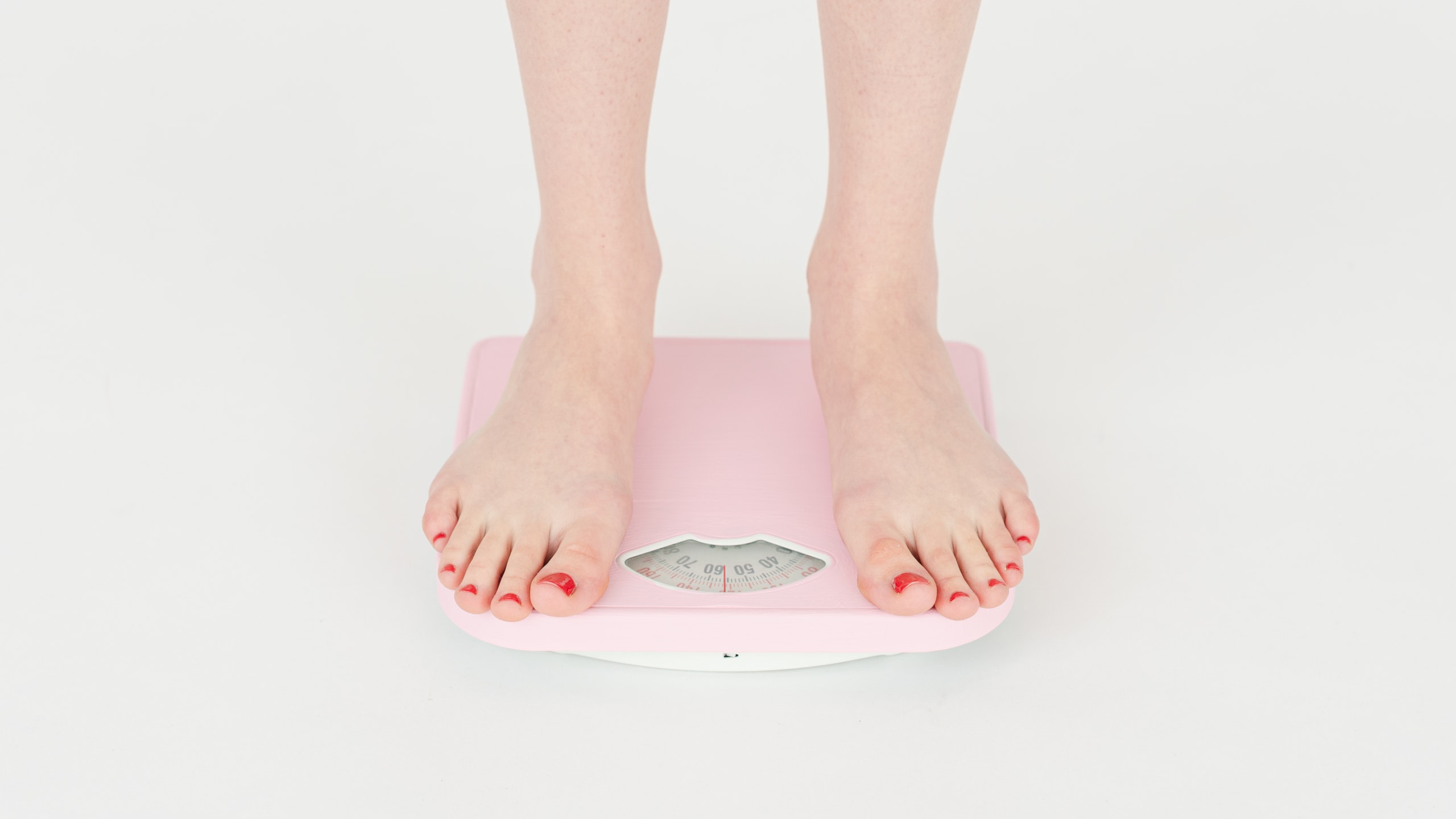 Woman checking weight on scales